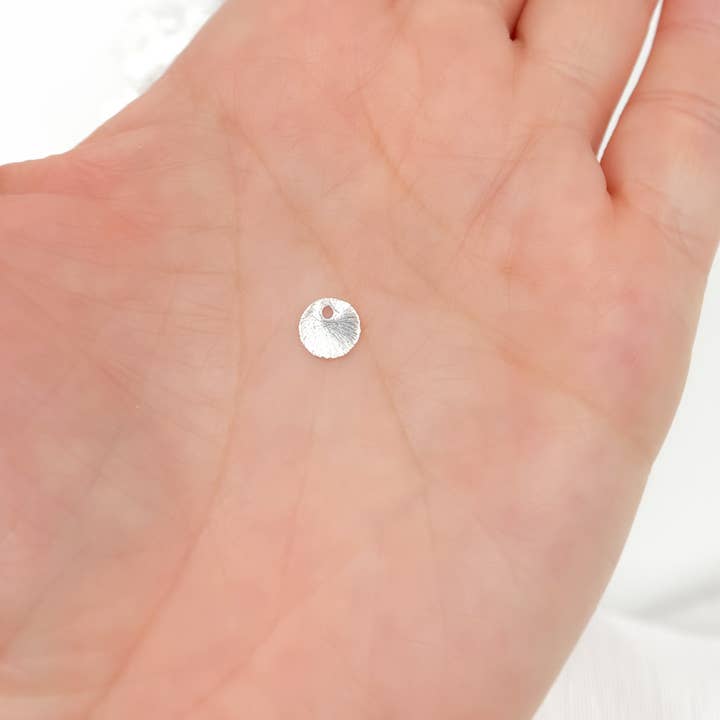 DSS1. 6MM White Sterling Silver Brushed Round Flat Disc Charm with a Single Hole for wholesale by Jewels & Chains