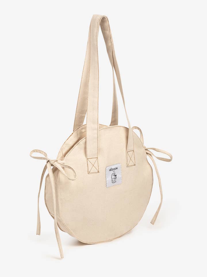 Borsa rotonda a spalla Paulette (naturale) per la vendita all'ingrosso da parte di Hédison