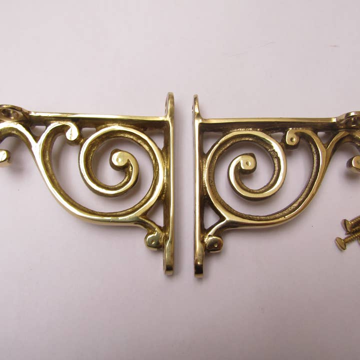 Pair Of Swirl Shelf Brackets Polished Brass for wholesale by IronmongeryWorld