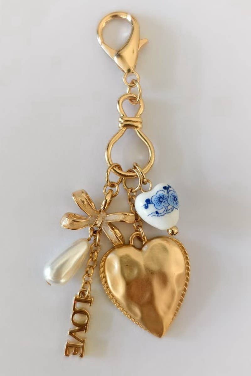 Gold PORCELAIN BOW HEART LOVE BAG CHARM | 80K011 for wholesale on Faire1