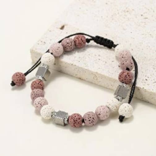 Round bead bracelets in natural lava stone tinted with pink shades for wholesale by INNOBIZ