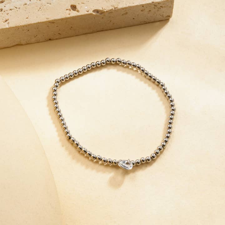 Bracelet élastique argenté billes lisses effet miroir pour la vente par joya