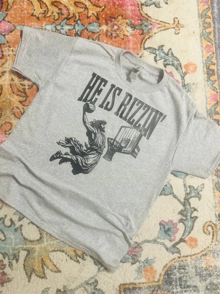He is Rizzin Graphic T-Shirt for wholesale by Sweet Southern Wholesale