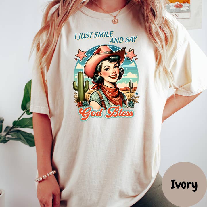 I Just Smile and Say God Bless Shirt, Retro Cowgirl Comfort Colors® Shirt, Western Christian Tee, Sassy Faith Shirt, Graphic Country Shirt for wholesale by Epic Life - Designed