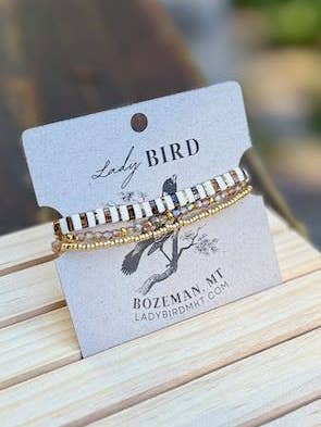 Ensemble de bracelets empilés avec perles Tila rayées ambre vif et blanc pour la vente par Lady Bird Market