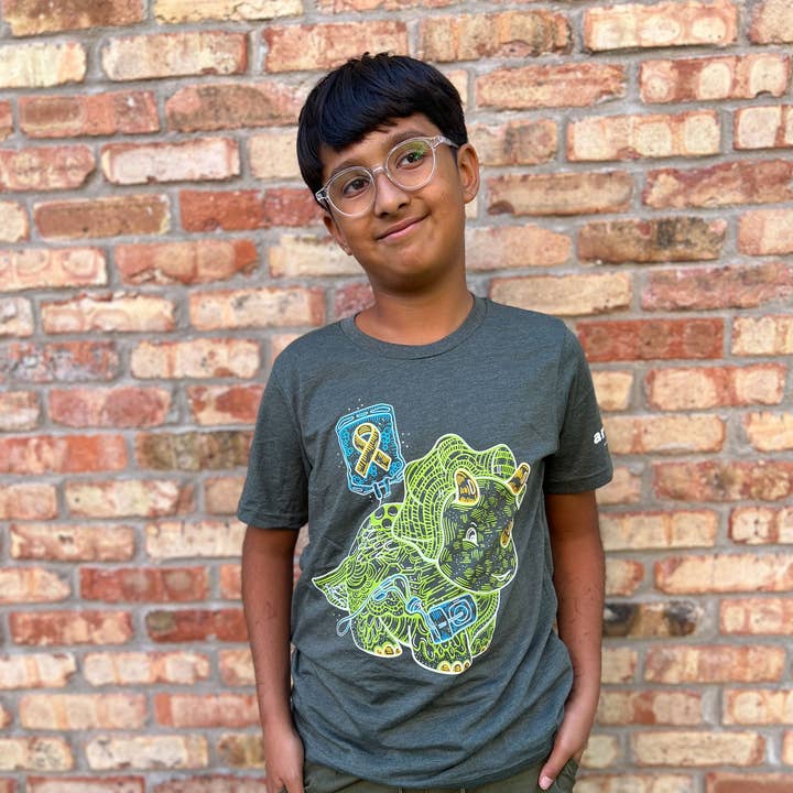 Juventude T-shirt de Sensibilização para o Cancro Infantil Dino "Encontra uma Cura" por atacado de Artery Ink