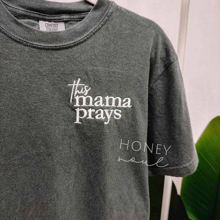Embroidered This Mama Prays Tee and other Purchase Wholesale t shirts with pocket. Free Returns & Net 60 Terms on Faire trending on Faire.