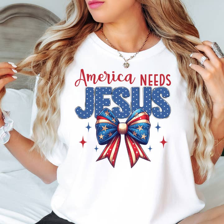 America Needs Jesus 4th of July Graphic Tee for wholesale by Happy Mail Wholesale