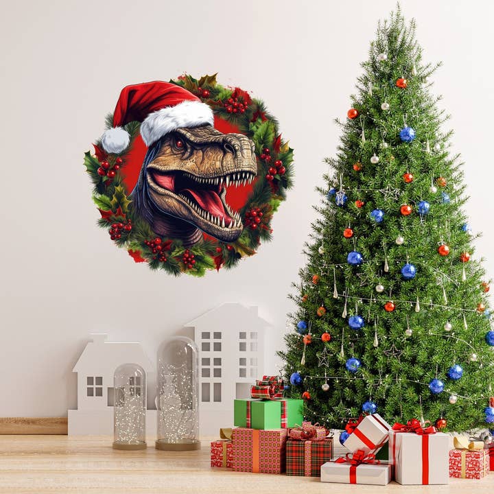 Dino 'Glædelig jul' krans vægklistermærke – sjov dinosaur T‑Rex i rød nissehue for engroshandel hos Decords