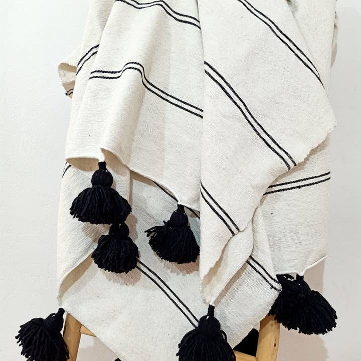 Handwoven White Moroccan Blanket with Black Pom Poms for wholesale by Melecraft