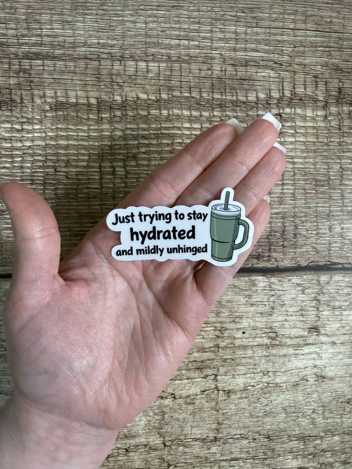 Funny Relatable Waterproof Sticker “Just trying to stay hydrated and mildly unhinged” Vinyl Decal Gift for wholesale by Laura Dawn Designs