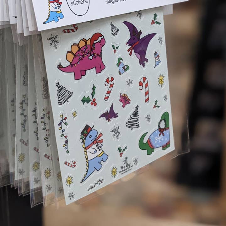 Winter Holiday Dinosaur Sticker Sheet for wholesale by Meg Huff Photography & Art