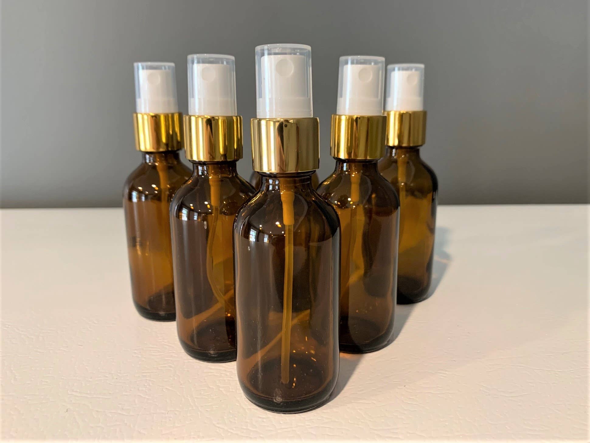The Bottle Shoppe - Wholesale Essential Oil Holder - 2oz Amber Glass Bottle with Gold Fine Mist Sprayer