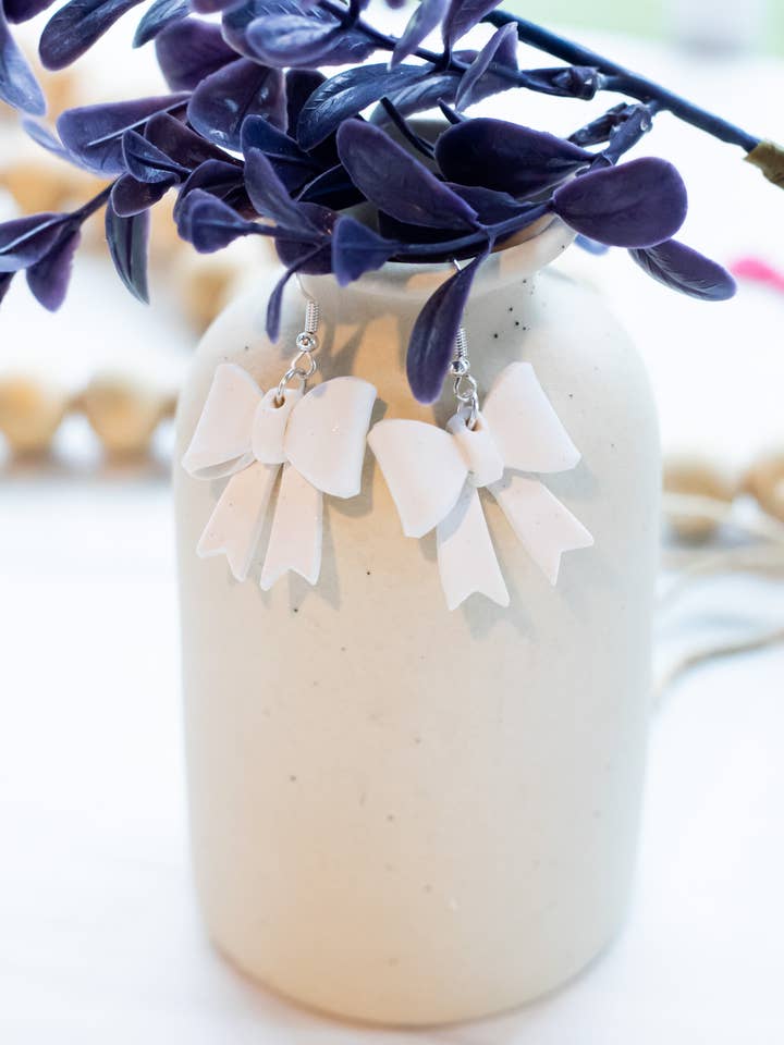 White Sparkle Bow Dangles for wholesale by EJ Clay Co