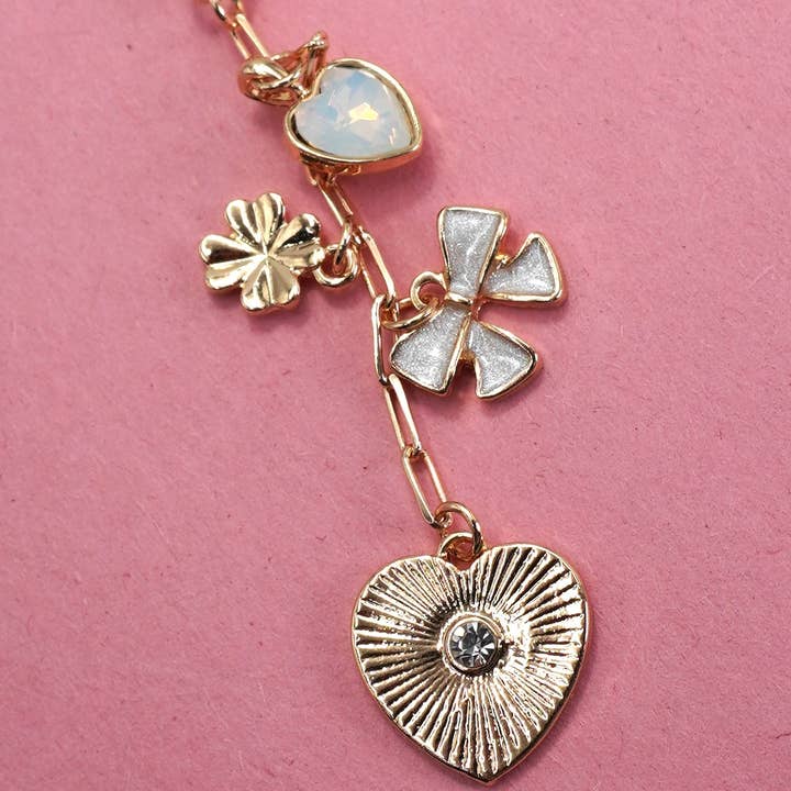 Gold HEART BOW CLOVER STONE BAG CHARM | 80K017 for wholesale on Faire0