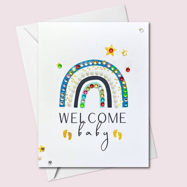 Welcome Baby Rainbow Blue Colours for wholesale by Russell Jeffery Design by Off By Heart Design