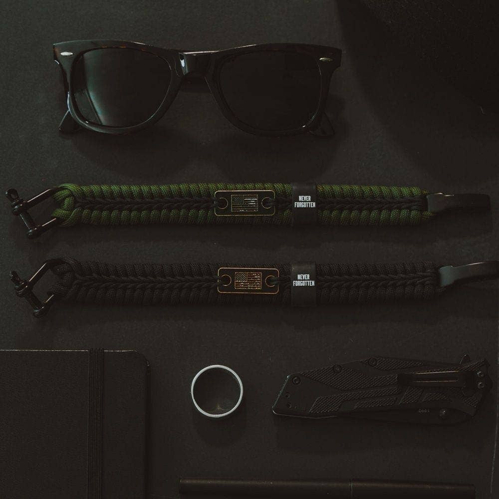 The Hero Company - Wholesale Woven/Braided Bracelet - Never Forgotten Black Paracord Bracelet: Helps Pair Veterans With A Service Dog Or Shelter Dog -Faire7