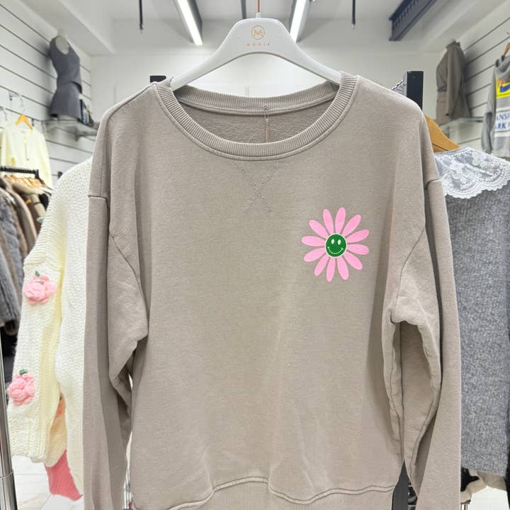 Round neck faded wash sweatshirt with Daisy print  and other Purchase Wholesale strandkleding. Free Returns & Net 60 Terms on Faire trending on Faire.