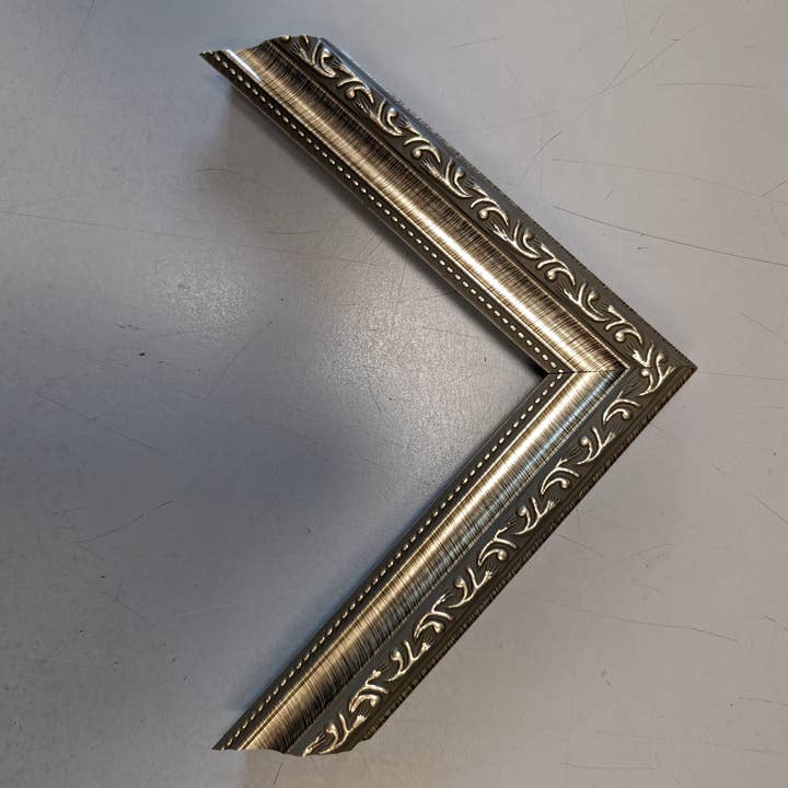 West Coast Frames LLC - Wholesale Picture frame - 1108 - 1-1/4" Silver Filigree Poly Picture Frame1