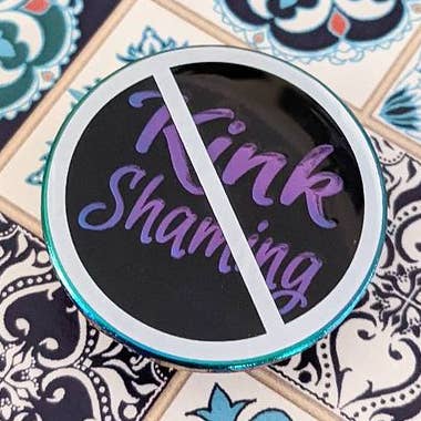 No Kink Shaming soft enamel pin with epoxy (black/rainbow version) for wholesale by Cunning Linguist Co.