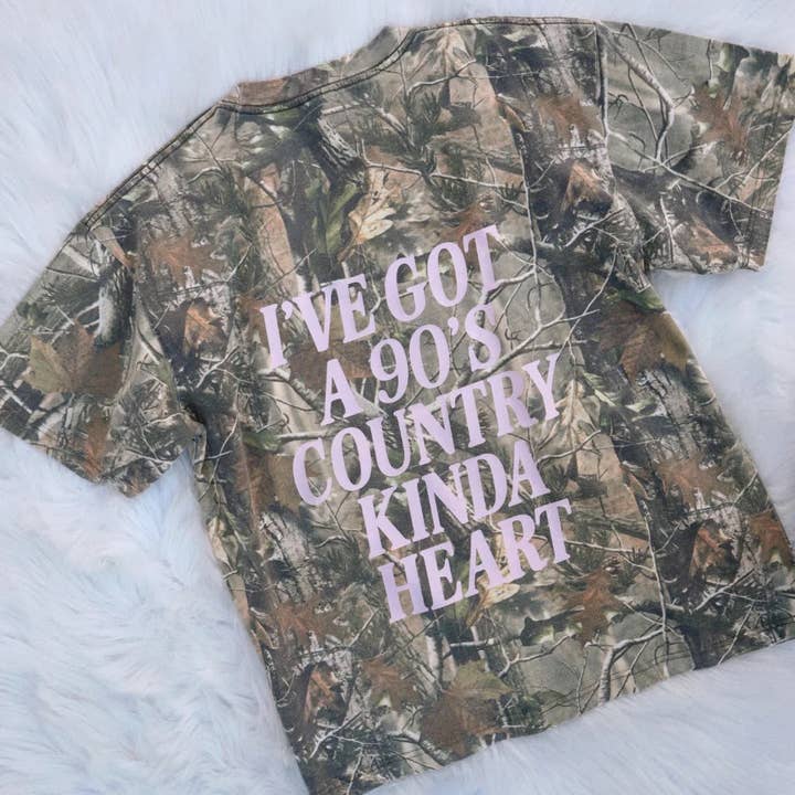 90's Country Kinda Heart Camo Tee and other Purchase Wholesale carharttshirt. Free Returns & Net 60 Terms on Faire trending on Faire.