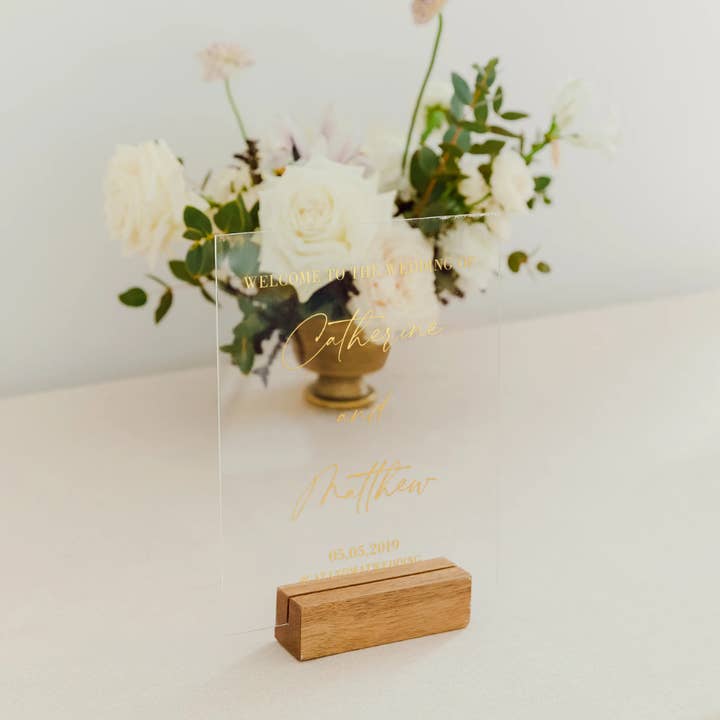 Foil Printed Clear Acrylic Tabletop Sign - Scripted Couple for wholesale by Weddingstar Inc.