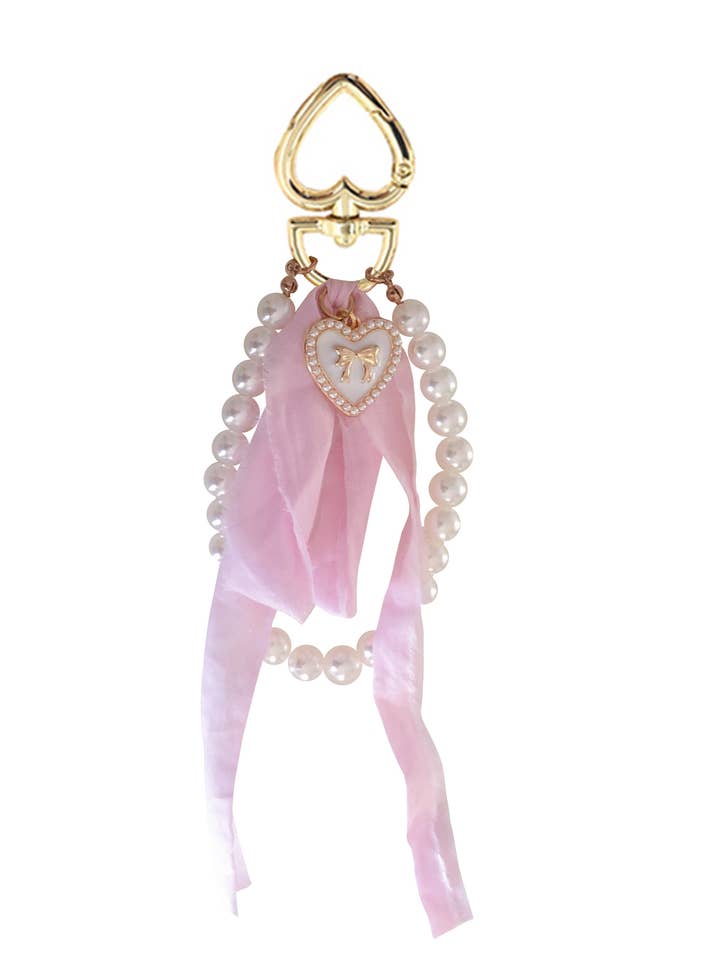 PORTE-CLÉS À NŒUD EN FORME DE CŒUR BLANC pour la vente par With Love Shop