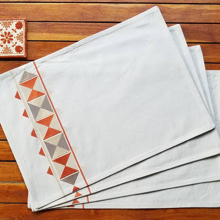 Cotton placemats embroidered with autumn colored triangles for wholesale by Indigostep