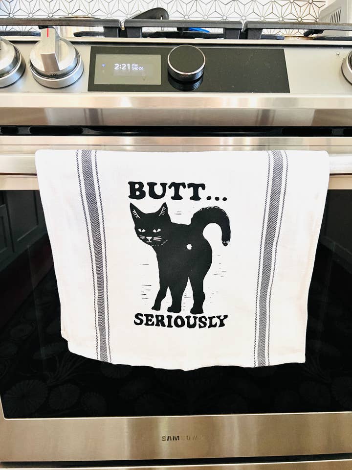 BUTT... SERIOUSLY Black Cat - tea towel, all cotton, kitchen, cooking, baking, food for wholesale by Pixel Palmer