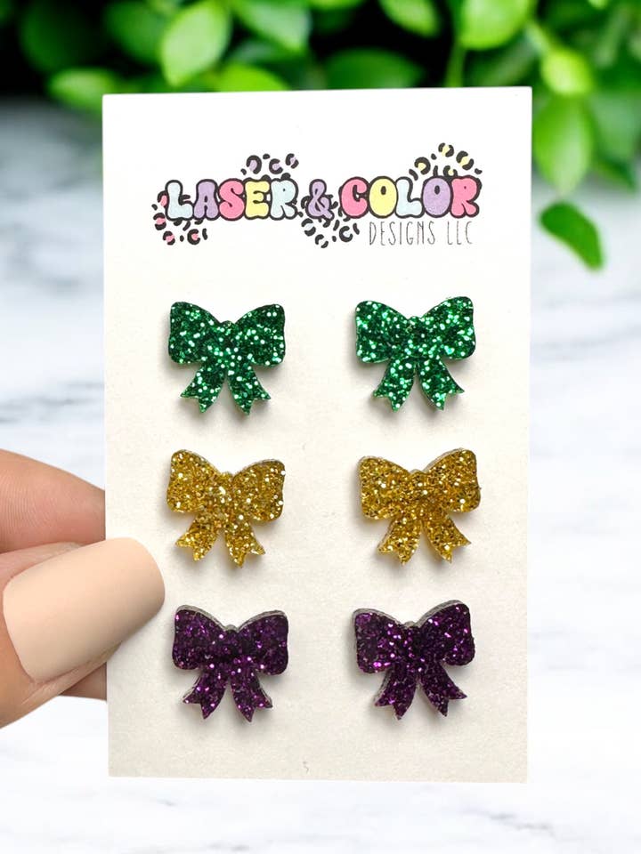 Ā Mardi Gras Bow Glitter Earrings, Bow Coquette Earrings for wholesale by Laser & Color Designs LLC