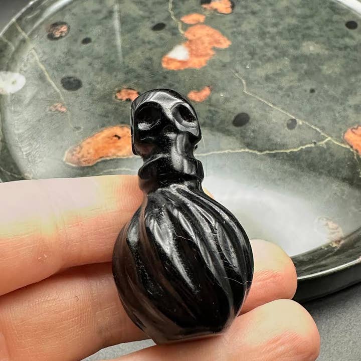 The Crystal Tabby - Wholesale Decorative Tabletop Object - Obsidian Poison Bottle - Round Bottle with Skulls2