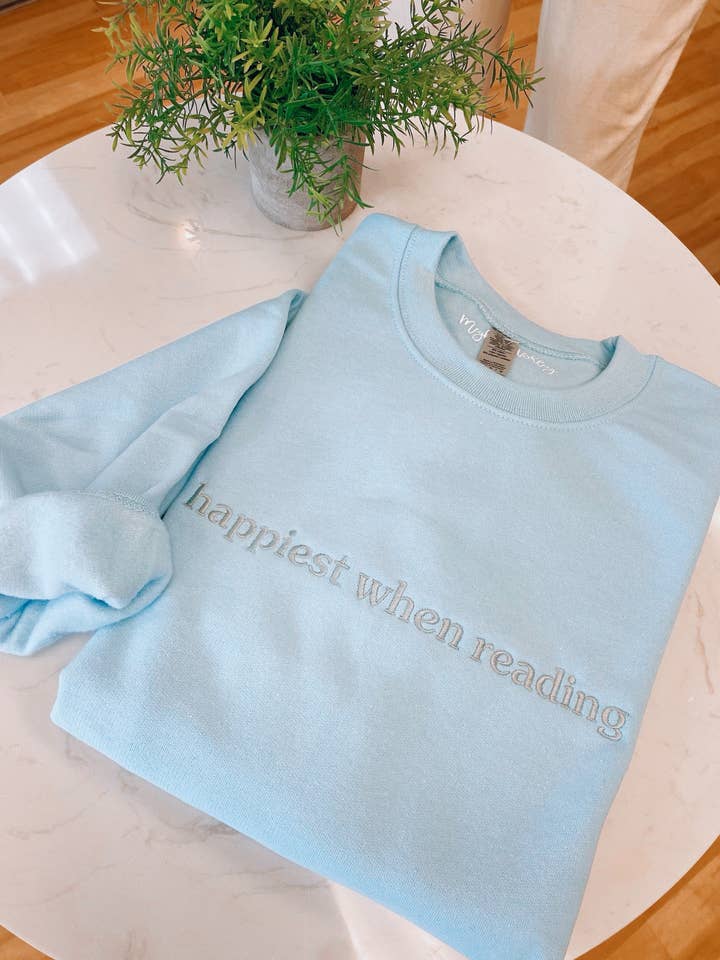 happiest when reading embroidered crewneck for wholesale by Meghan Ashley Designs Inc.