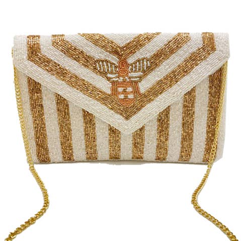 GOLDFARBENE, PERLENBESETZTE CLUTCH MIT WEISSEN STREIFEN für den Großhandel von Pizzazz, Inc.
