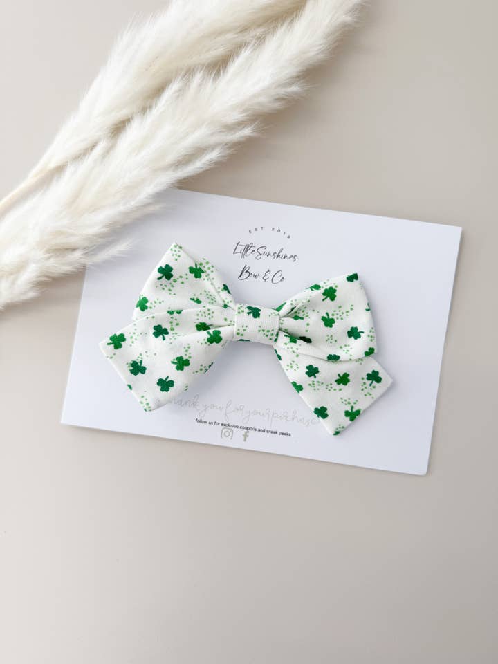 Mini White & Green Clovers St Patricks Day Pinwheel Bow for wholesale by Little Sunshines Bow & Co