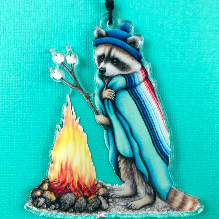 Holiday ornament raccoon roasting marshmallows for wholesale by Abundance Illustration