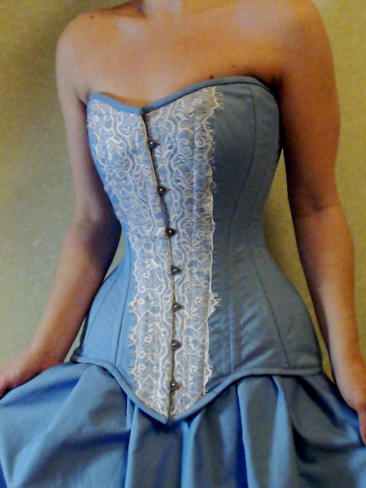 Light blue steel-boned overbust hourglasses corset for tight lacing covered by chantilly laces. Lace Addicted Corsettery collection. for wholesale by corsettery