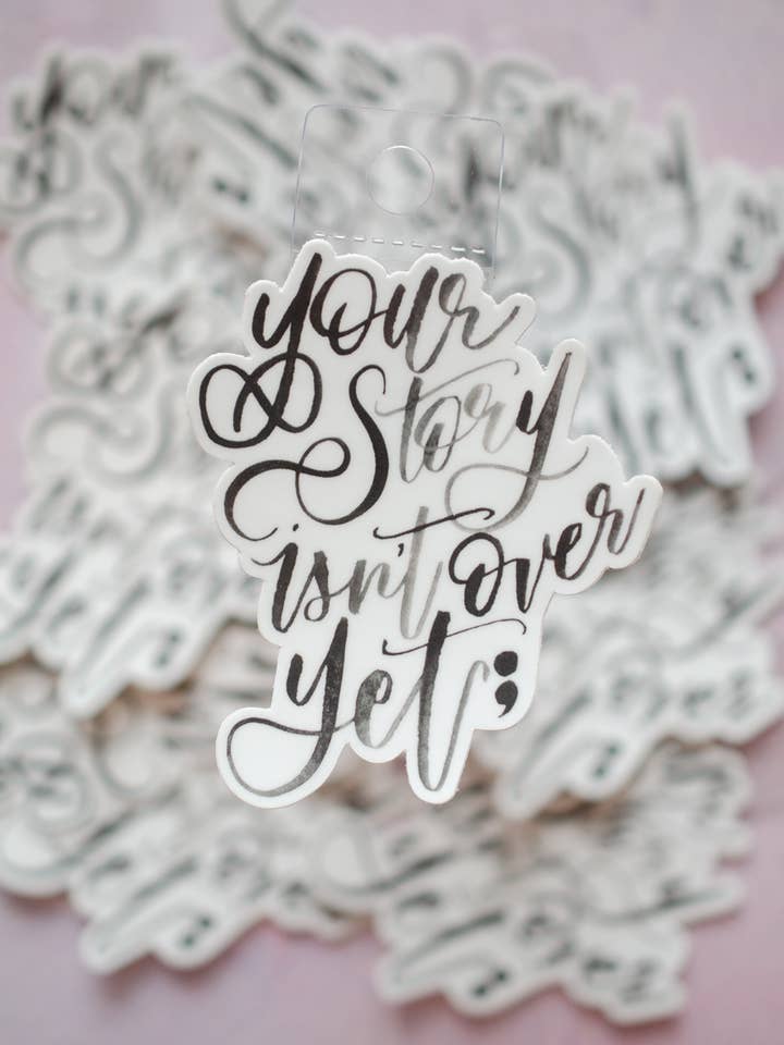 Your Story Isn't Over Yet Hand Lettered Die Cut Sticker for wholesale by The Smokey Rose Press
