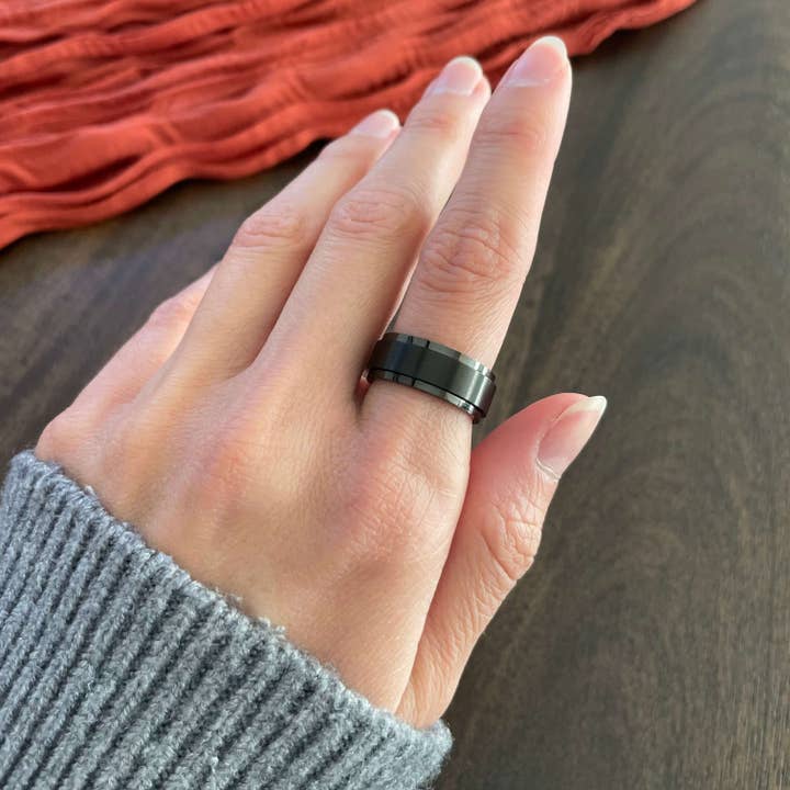 Edge black spinner ring, minimal fidget ring for wholesale by OrnaMental Health