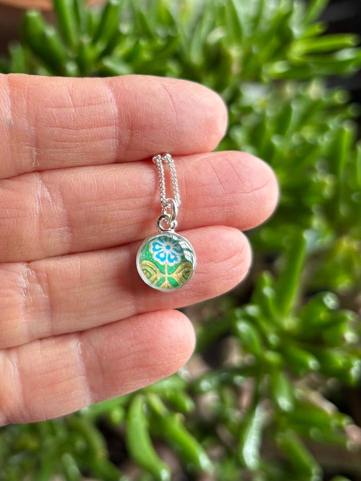 Tiny silver pendant necklace- turquoise flower on green for wholesale by joeyfivecents