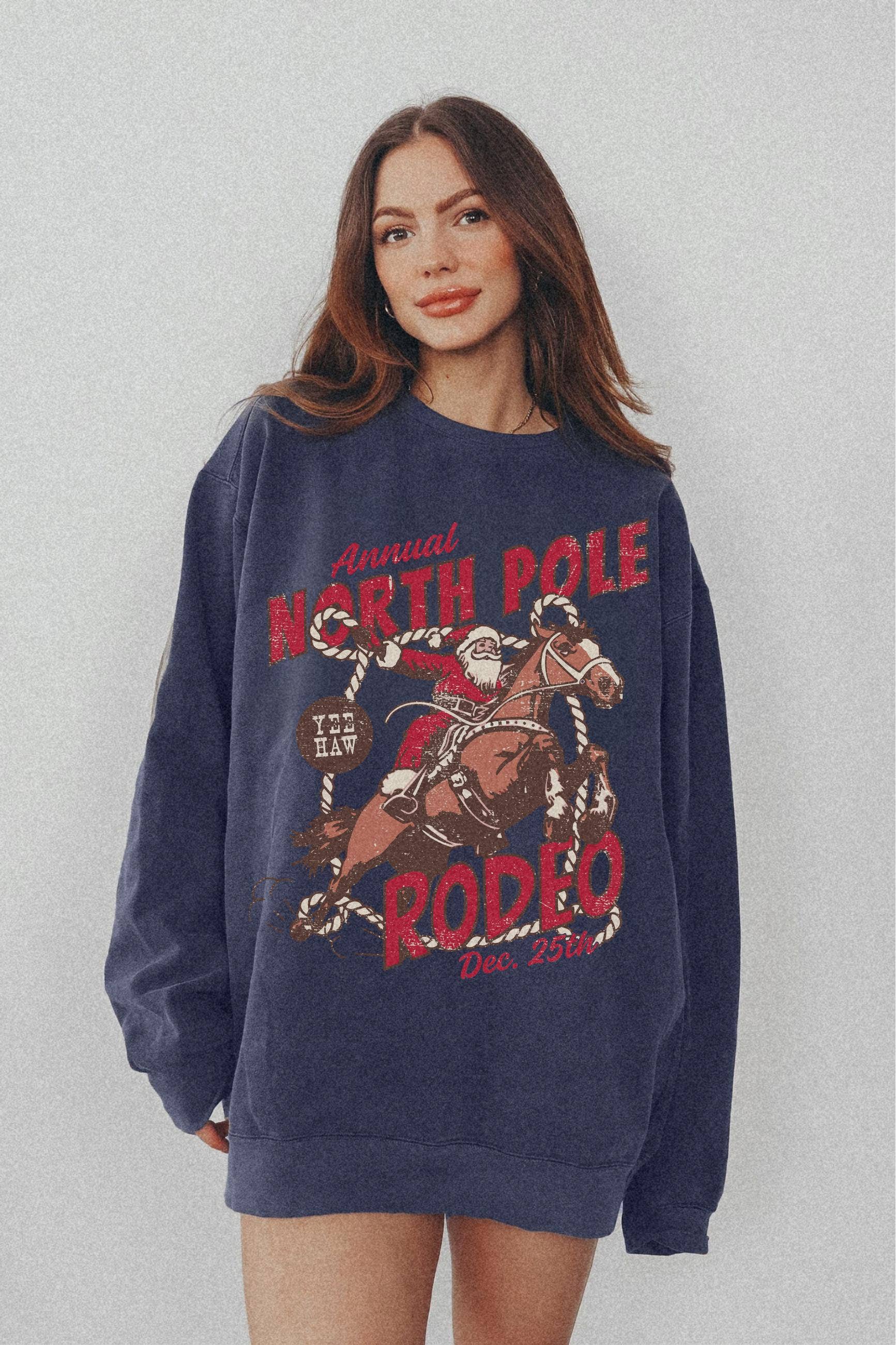 NVC Ecommerce LLC - Wholesale T-Shirt (Graphic) - Women's - North Pole Rodeo Sweatshirt, Cowboy Santa Shirt1