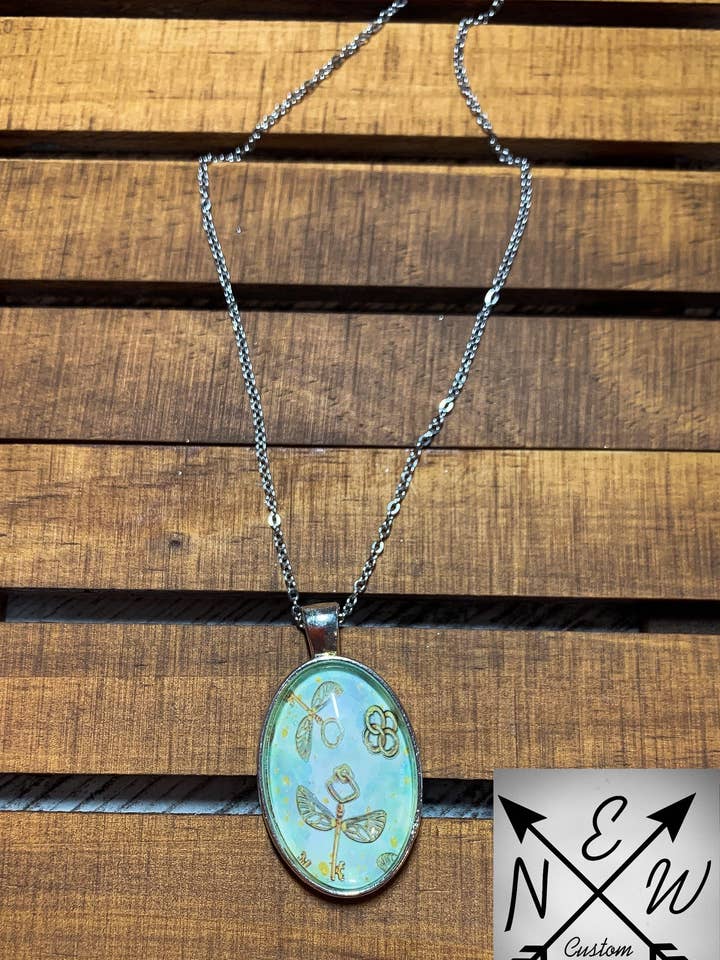 Magical Flying Keys Oval Cabochon Necklace for wholesale by N.E.W. Custom Creations Co LLC