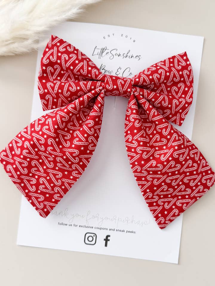 Red Candy Cane Christmas Sailor Bow for wholesale by Little Sunshines Bow & Co