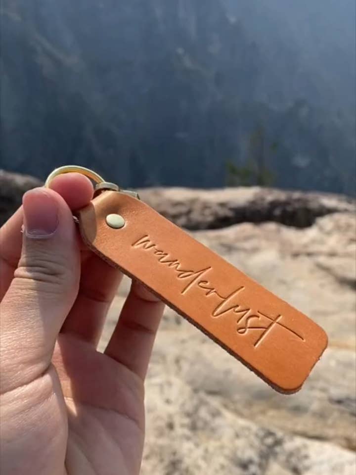 "Wanderlust" Script Keychain for wholesale by Twin Sparrow
