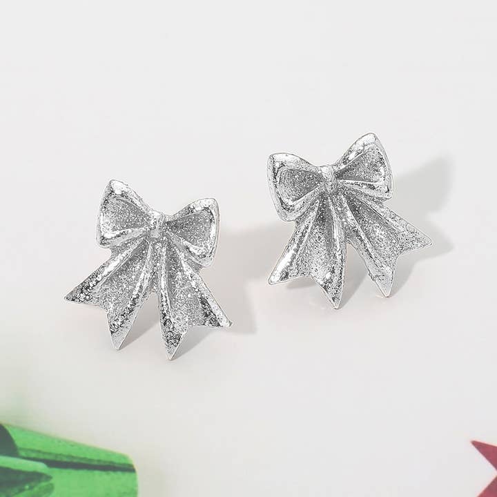 Boucles d'oreilles clous nœud pailleté pour la vente par Sensibling Corp.