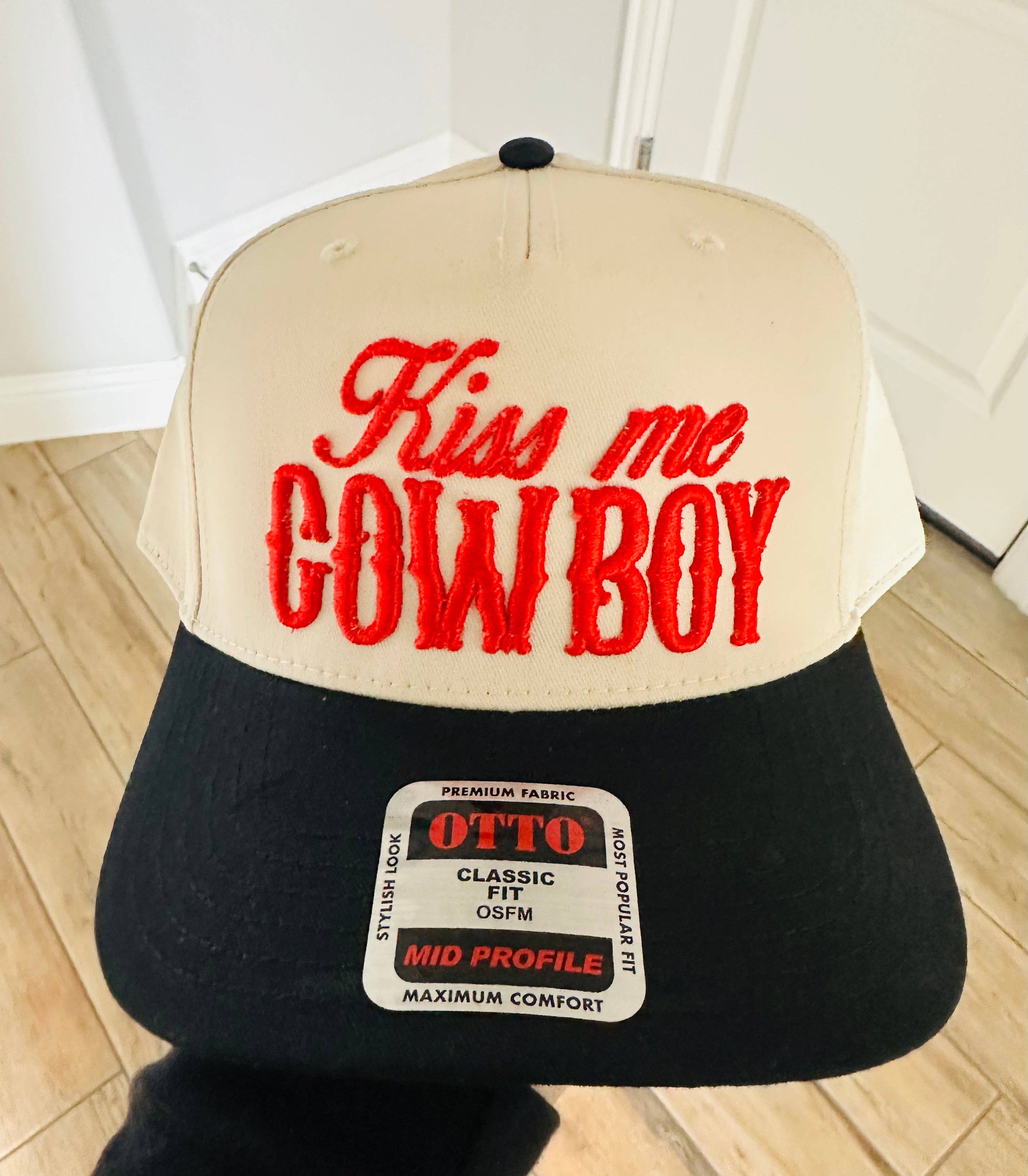 Black Kiss Me Cowboy PUFF EMBROIDERY TRUCKER HAT for wholesale on Faire