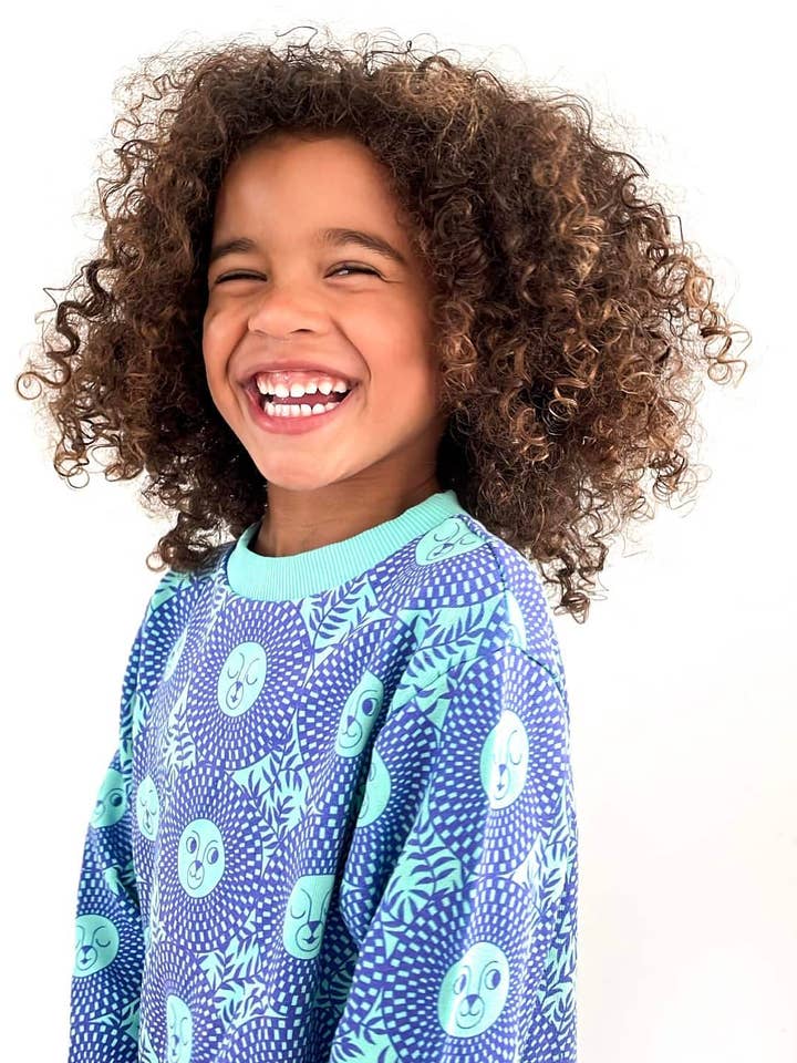 Unisex Lion Sweatshirt in Green on Purple for wholesale by Tilly & Tojo