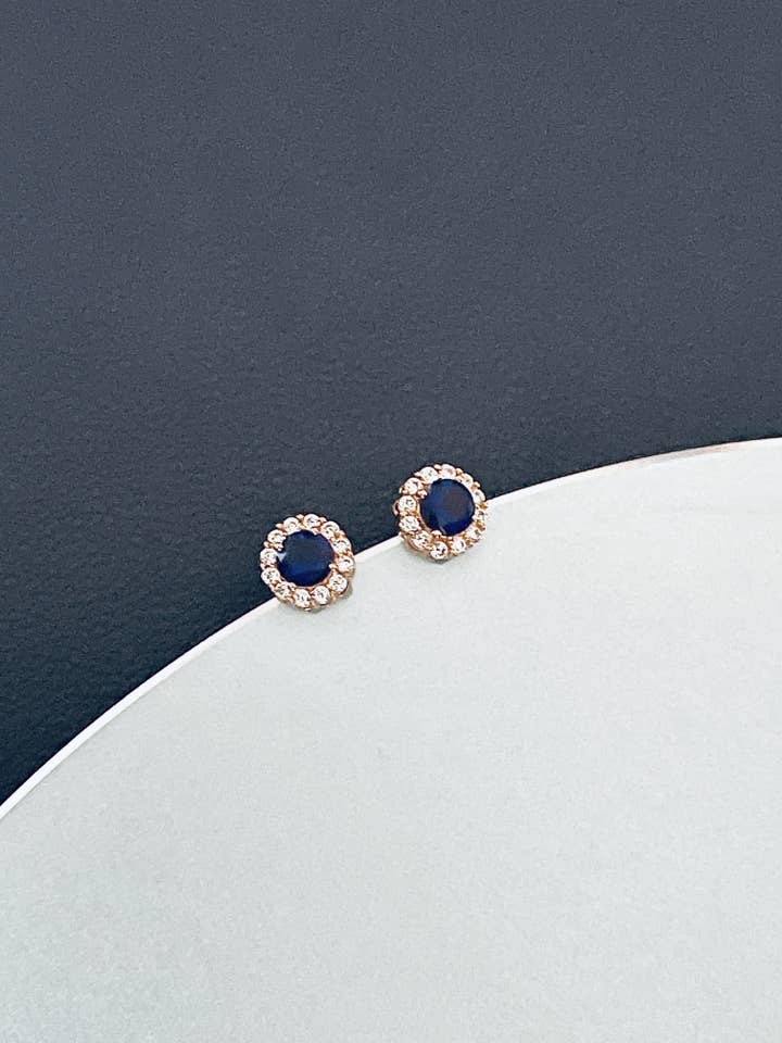 AVA - Circle-Setting Sapphire Blue CZ Crystal Stud Earrings In Gold for wholesale by JohnnyB Jewelry