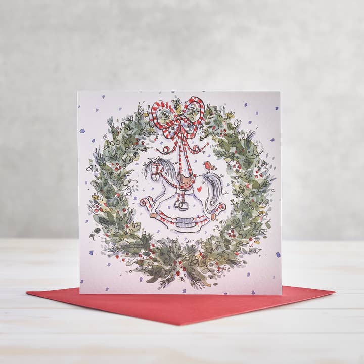 Tarjeta de Felicitación Navideña con Caballito de Madera y Corona para venta al por mayor de Helen Wiseman Illustration