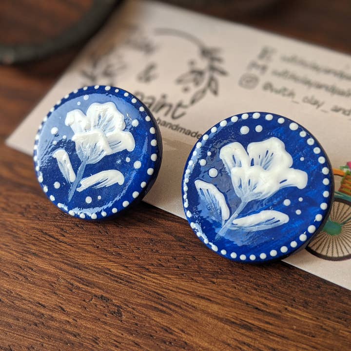 Cameo earrings, blue studs with white flowers for wholesale by With Clay & Paint