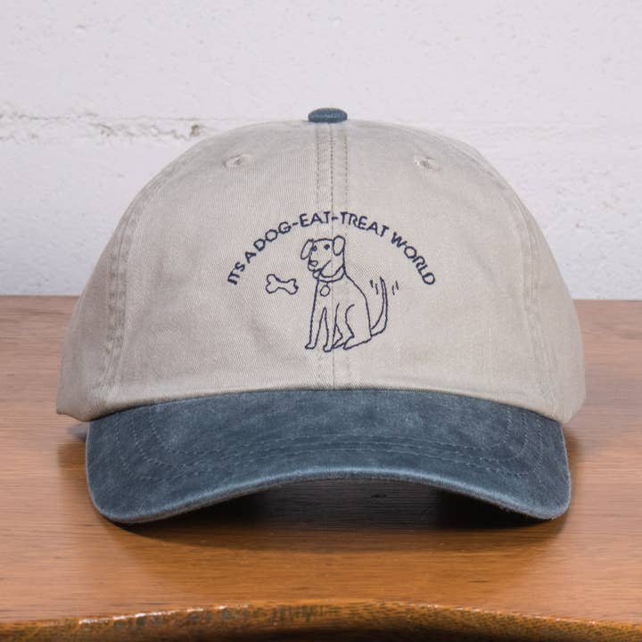 It's a Dog-Eat-Treat World Dad Hat for wholesale by Crewel and Unusual